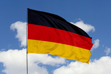 Germany flag isolated on the blue sky background. close up waving flag of Germany. flag symbols of Germany. Concept of Germany.