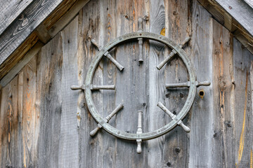 Wooden steering wheel hanging on the wall