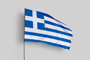 Greece flag isolated on the blue sky background. close up waving flag of Greece. flag symbols of Greece. Concept of Greece.