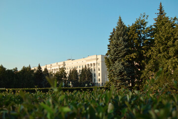 Fototapeta premium Trees and historic building on blue sky background