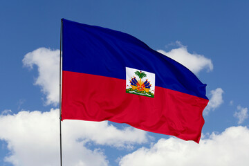 Haiti flag isolated on the blue sky background. close up waving flag of Haiti. flag symbols of Haiti. Concept of Haiti.