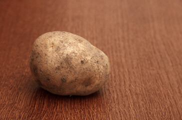 one raw potatoe on the table