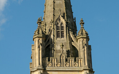 Fototapeta na wymiar Top part of cathedral tower with Gothic architecture at Saffron Walden, England