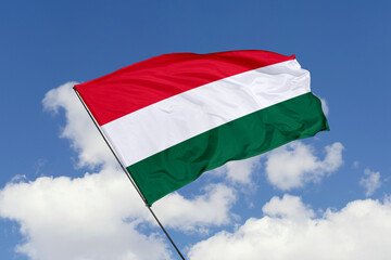 Hungary flag isolated on the blue sky background. close up waving flag of Hungary. flag symbols of Hungary. Concept of Hungary.
