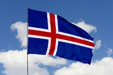 Iceland flag isolated on the blue sky background. close up waving flag of Iceland. flag symbols of Iceland. Concept of Iceland.
