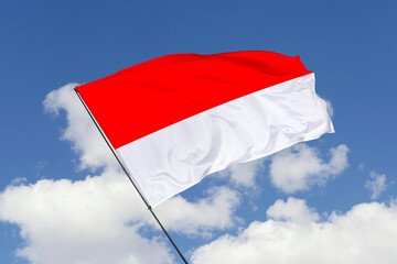 Indonesia flag isolated on the blue sky background. close up waving flag of Indonesia. flag symbols of Indonesia. Concept of Indonesia.