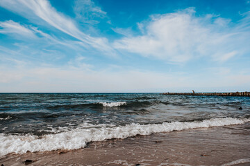 baltic sea coast on a sunny day, blue sky and strong waves