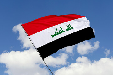 Iraq flag isolated on the blue sky background. close up waving flag of Iraq. flag symbols of Iraq. Concept of Iraq.