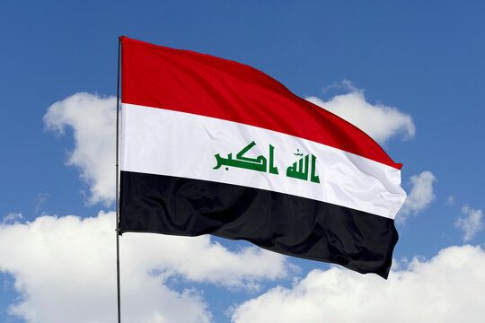 Iraq flag isolated on the blue sky background. close up waving flag of Iraq. flag symbols of Iraq. Concept of Iraq.