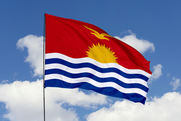 Fototapeta premium Kiribati flag isolated on the blue sky background. close up waving flag of Kiribati. flag symbols of Kiribati. Concept of Kiribati.