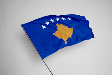 Kosovo flag isolated on white background. close up waving flag of Kosovo. flag symbols of Kosovo. Concept of Kosovo.