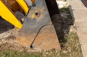 The tractor is working with rubble on the road.