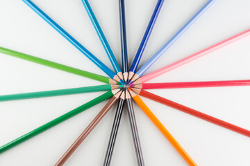 set of colored pencils lined by an arc