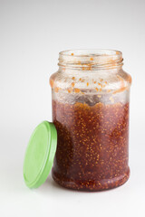 glass jar with raspberry jam isolated