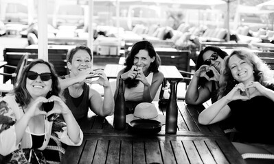 Women best friends sitting in summer cafe on the beach