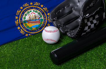 Baseball bat, glove and ball near New Hampshire flag on green grass background