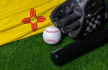 Baseball bat, glove and ball near New Mexico flag on green grass background