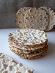 Stack of round crispbreads on white/textile background