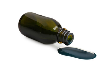 Overturned bottle and spilled brilliant green on white background