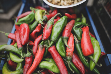 Shallow depth of field (selective focus) image with hot red and green peppers sold by a Romanian man from his garden in a rural area.