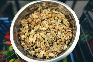 Shallow depth of field (selective focus) image with walnuts sold by a Romanian man from his garden in a rural area.