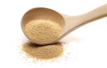 Amaranth seed pile in wooden spoon isolated on white  