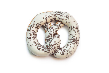 White glazed pretzel with chocolate chips isolated on a white background