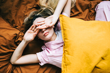 Young caucasian woman waking up alone in the morning.