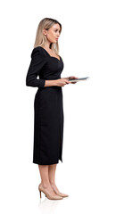 Full length side view attractive businesswoman in black formal dress with confident look holding a business planner or notebook, isolated over white background. Concept of personal growth and success