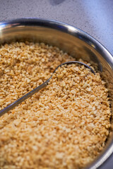 Delicious seasoning, close-up of fried crushed peanuts
