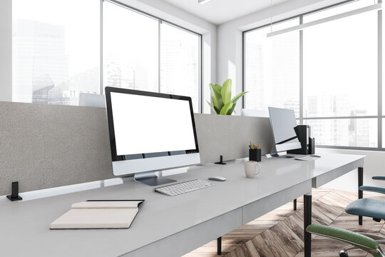 White office room interior with desktop computers on the tables. Mockup screen