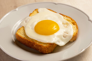 Fried egg above a toast.