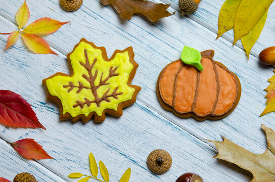 Gingerbread cookies in the form of a maple leaf and pumpkin on a wooden table. Happy Thanksgiving Day autumn holiday concept.