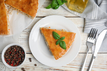 Delicious meat pie served on white wooden table, flat lay