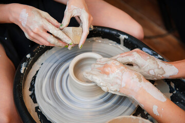 Woman hands doing pottery in pair
