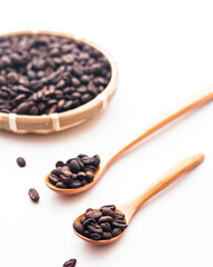 Fototapeta premium coffee beans in a wooden spoon with a basket