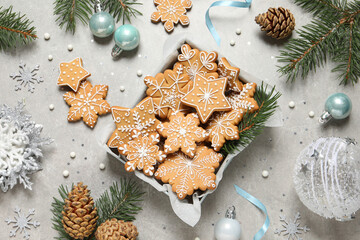 Tasty Christmas cookies and festive decor on light grey table, flat lay