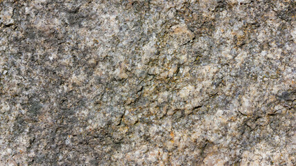 Natural stone texture. Granite surface of sheer cliff. Solid rock close-up