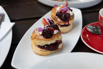 freshly baked scones with marmalade at breakfast table