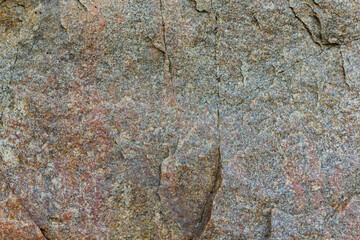 Granite rocks in sunlight. Large sheer granite rock. Hard rock on a sunny day