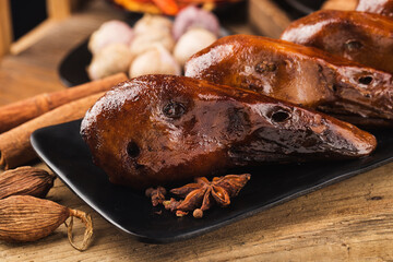 Delicious spiced duck head on a plate