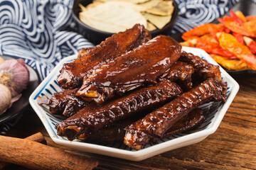The duck's wings were boiled and placed on a  plate