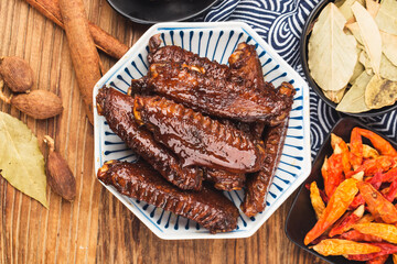 The duck's wings were boiled and placed on a  plate