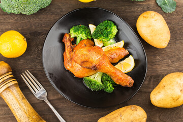 Grilled chicken leg with boiled potatoes and vegetable