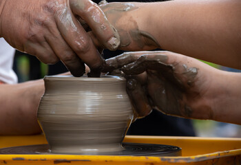 Master class on modeling of clay on a potter's wheel In the pottery workshop