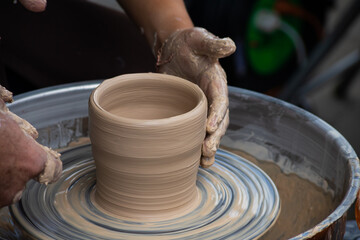 Master class on modeling of clay on a potter's wheel In the pottery workshop