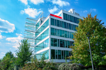 Fototapeta premium Modern office building with glass facades sorrounded by nature