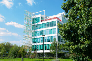 Modern office building with glass facades sorrounded by nature