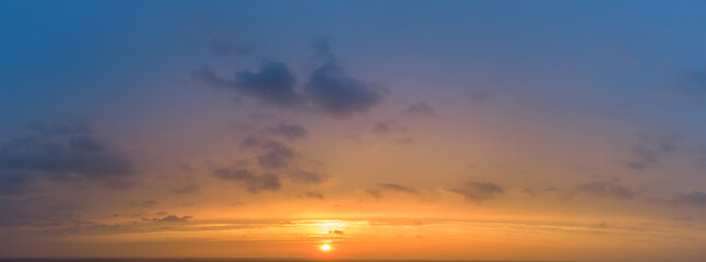 Fototapeta na wymiar Sunset panorama with blurred colorful sky and orange sun.
