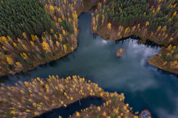 Aerial view of small lakes surrounded by autumn forest.